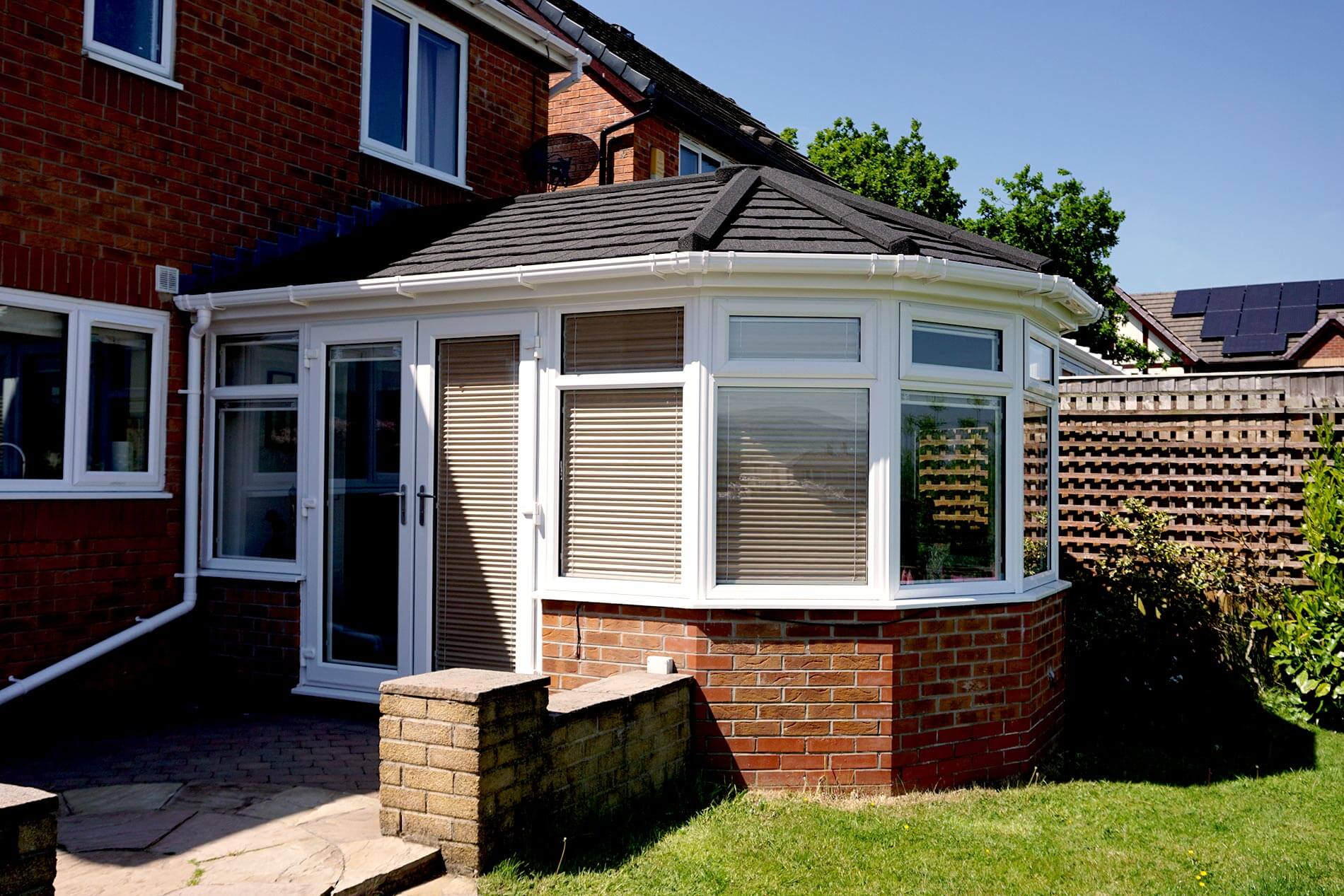 An existing conservatory with new tiled solid roof to transform it into an extension