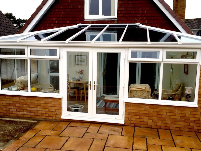 White conservatory installation in Edwardian style with brick base and uPVC windows